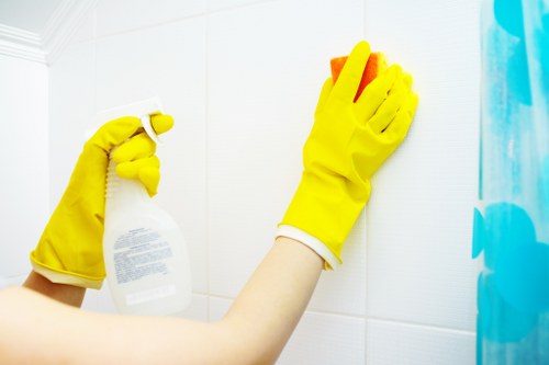 Cleaner handling cleaning chemicals safely with protective measures